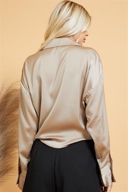 Back view of a woman wearing a TAUPE TIE-FRONT TOP from Raggdoll Boutique, showcasing trendy coastal style.