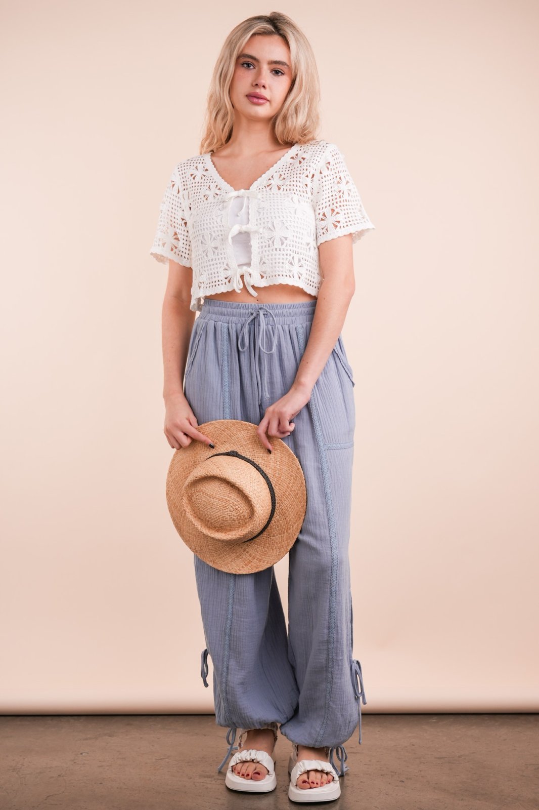 Stylish crochet crop top with front ties, perfect for coastal boutique clothing and beachside adventures.