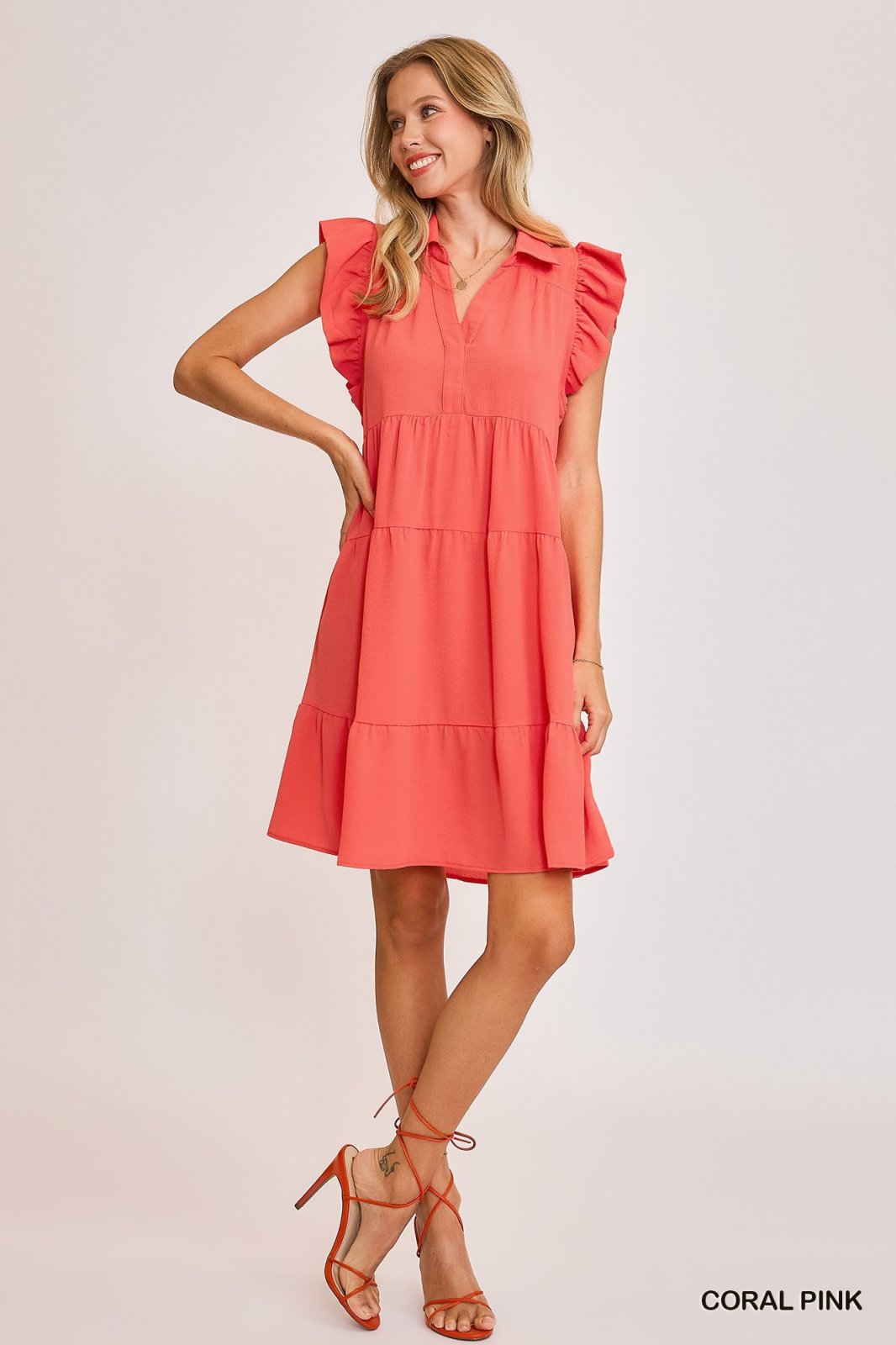 Janey Dress in Coral Pink from a coastal boutique, ideal beach dress for tropical vacations and Port Aransas shopping.
