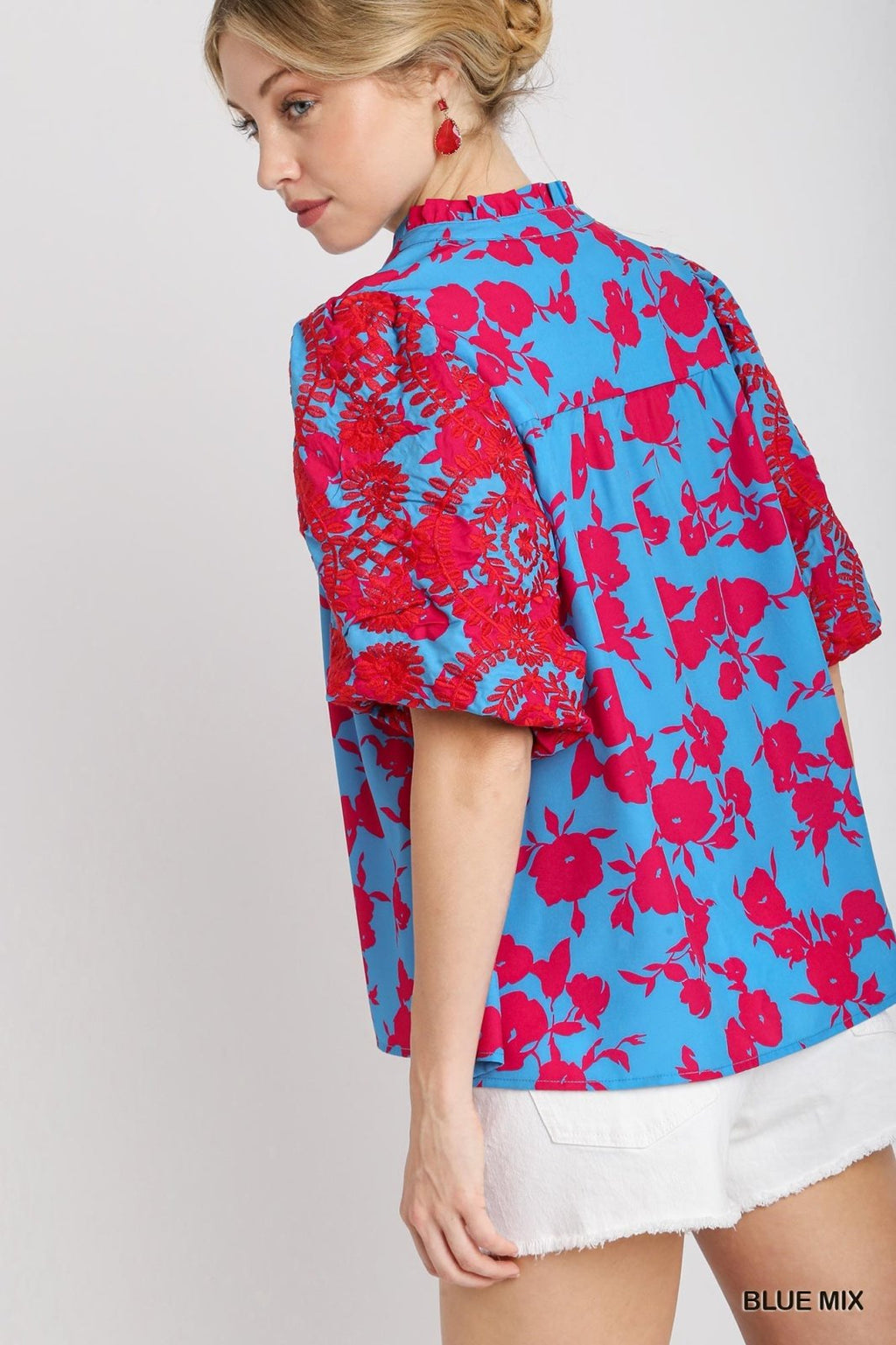 Chic two-tone blue floral top with ruffle split neckline, perfect for coastal boutique clothing and tropical vacation dresses.