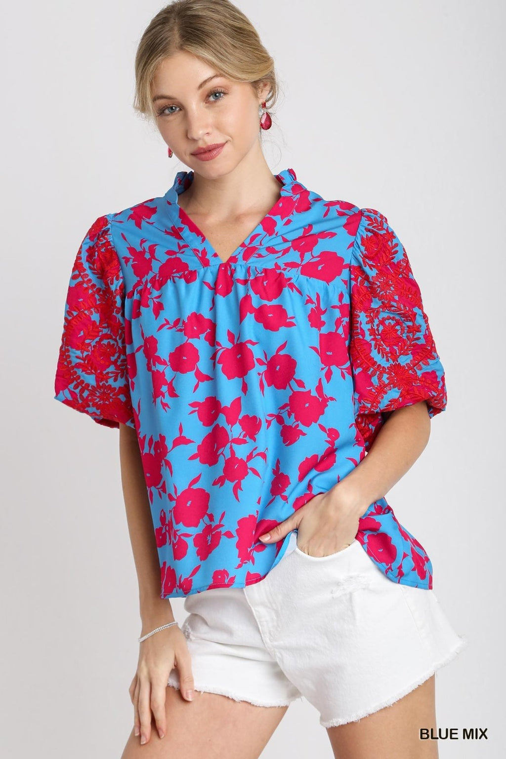 Stylish two-tone blue top with ruffle neckline, perfect for casual wear, available at Port Aransas boutique.