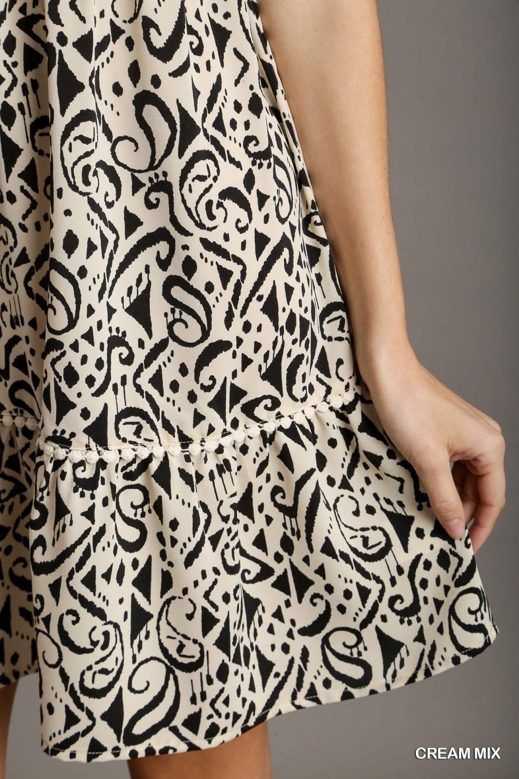 Close-up of the Kara Dress from Raggdoll Boutique featuring trendy coastal style in a cream mix pattern.