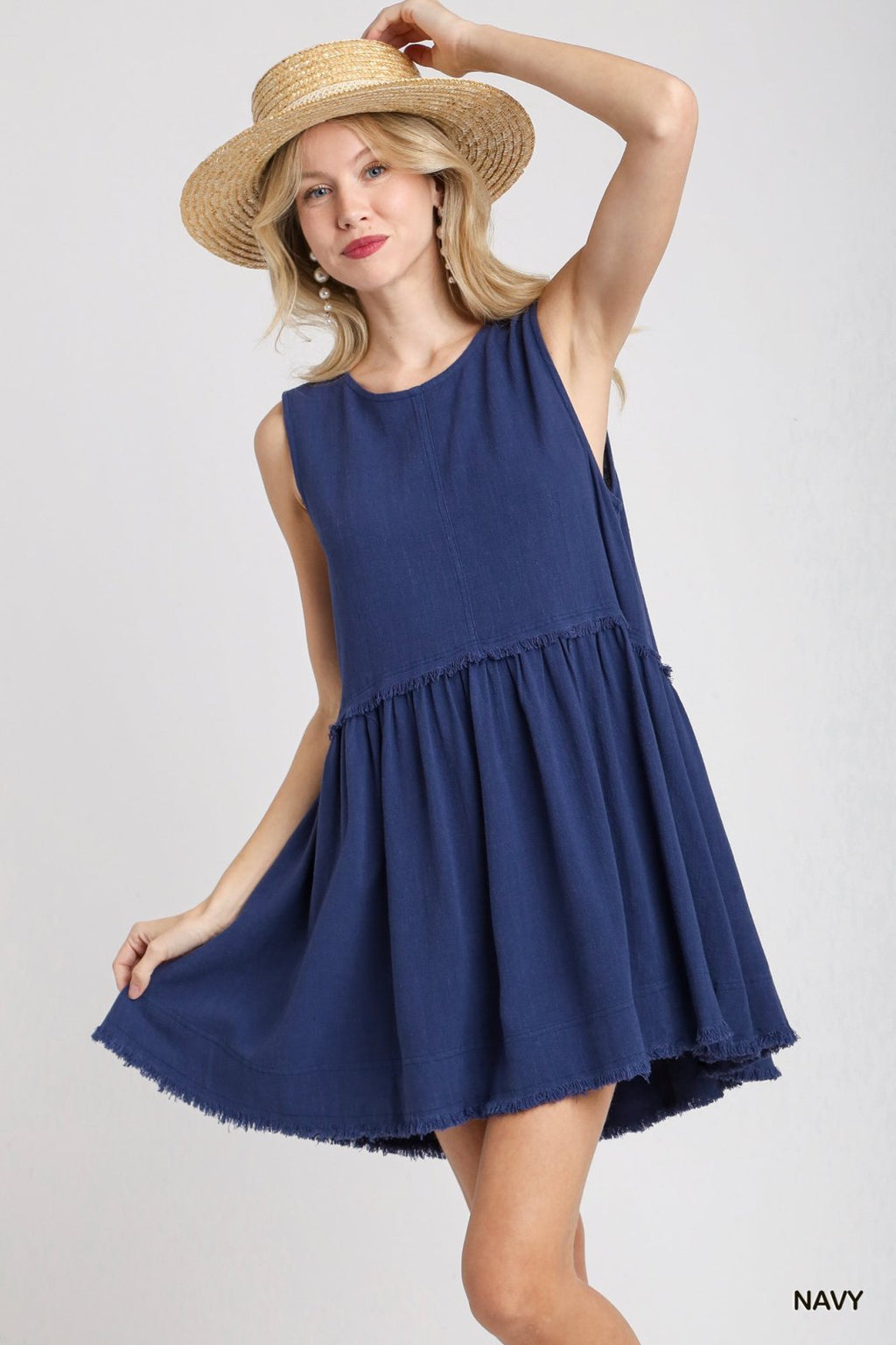 Woman wearing the Laurel Dress from Raggdoll Boutique, showcasing trendy coastal style at a Port Aransas boutique.