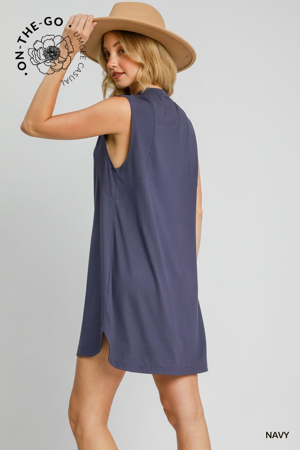 Navy Gia Dress from coastal boutique, perfect for active days and beach outings, featuring a sporty crewneck and hi-lo hemline.