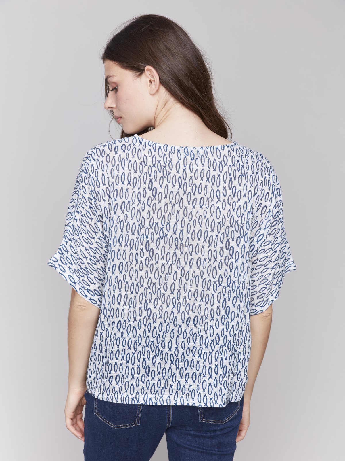 Stylish dolman cotton blouse featuring a blue and white design, perfect for summer days at a coastal boutique.