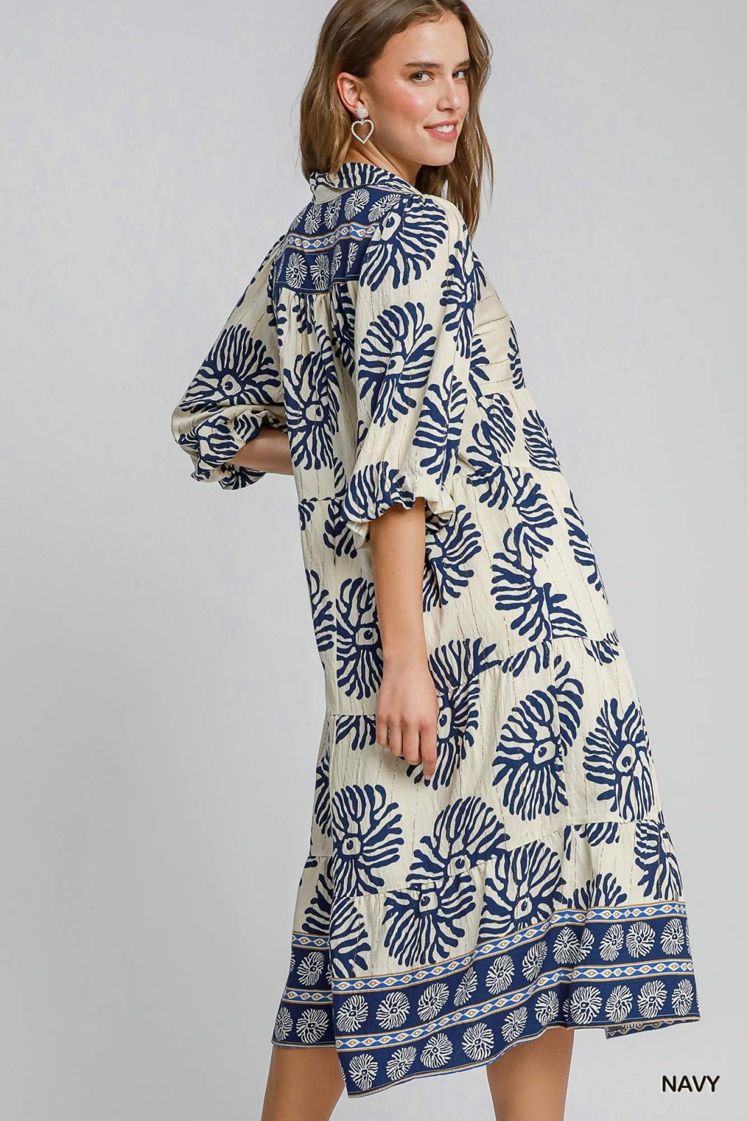 Nadine dress in navy with floral print, perfect for coastal boutique clothing and tropical vacation styles.