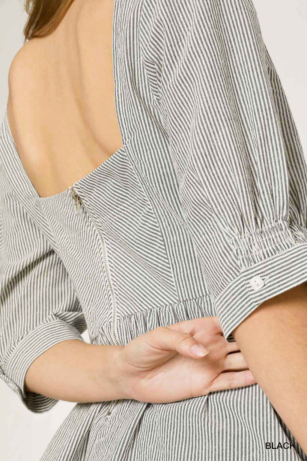 Black and white top featuring a square neckline and back zipper detail, perfect for coastal boutique clothing and stylish outfits.