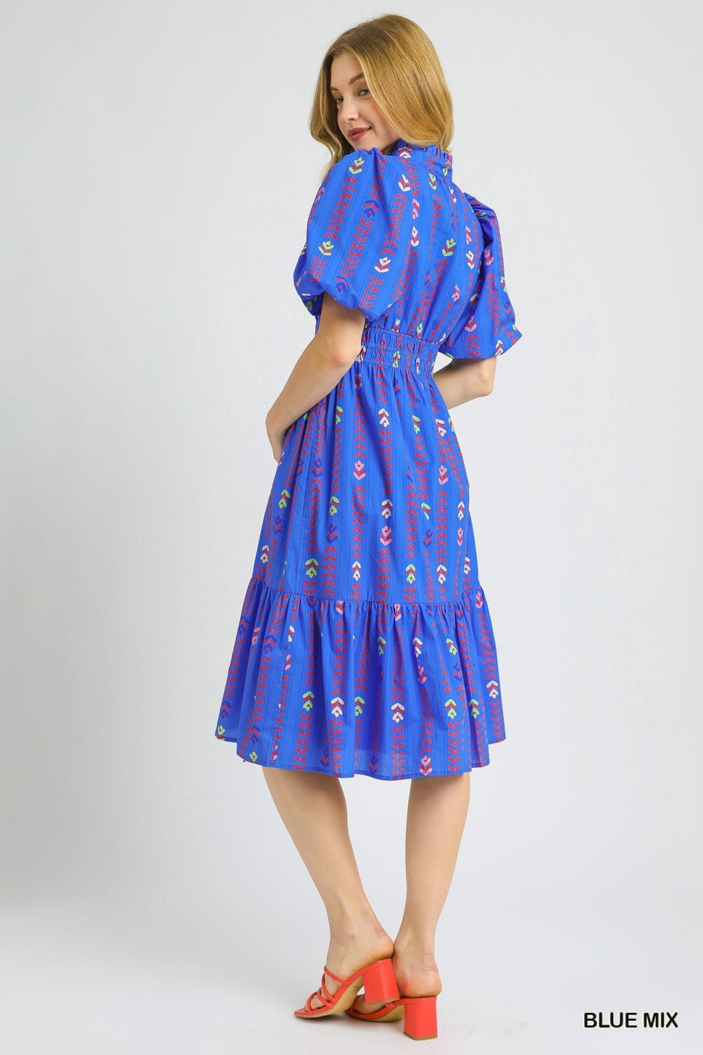 Blue mix smocked waist midi dress from a coastal boutique for stylish summer outings and tropical vacations.