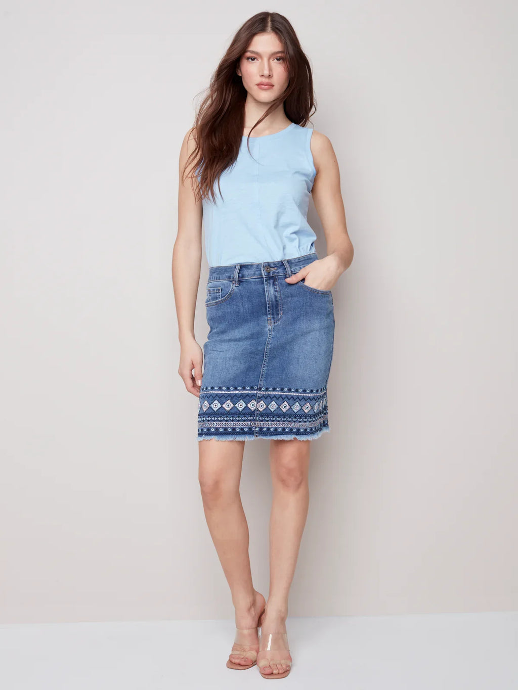 Denim embroidered-cuff skirt styled with a blue top, perfect for coastal boutique clothing and curvy plus size fashion.