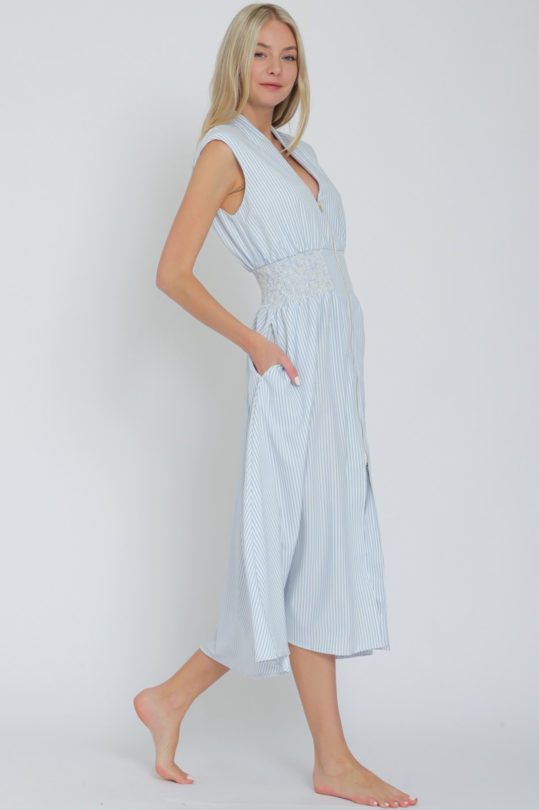 Light blue striped Catherine Dress with smocked waist, perfect for coastal boutique clothing and stylish spring looks.