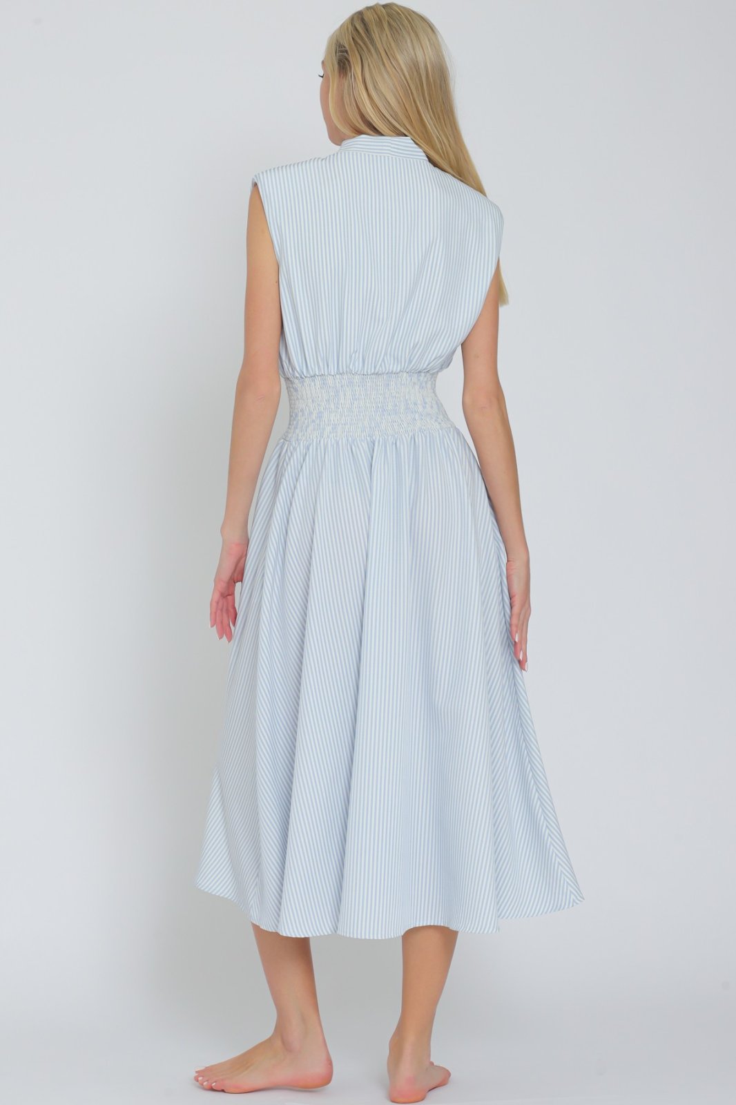 Back view of Catherine Dress in light blue with white stripes; perfect for spring from a coastal boutique.
