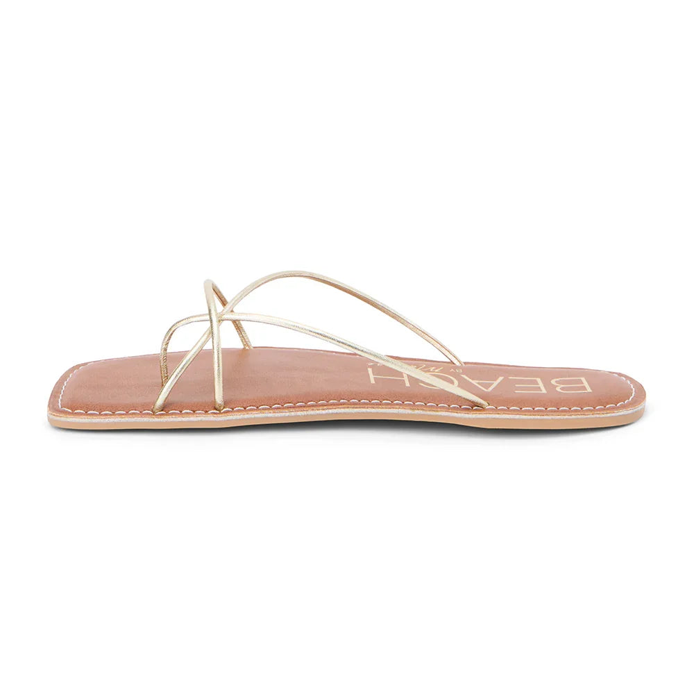 Coastline Gold Sandal for women, stylish strappy flat design, perfect for beach dresses and tropical vacations.