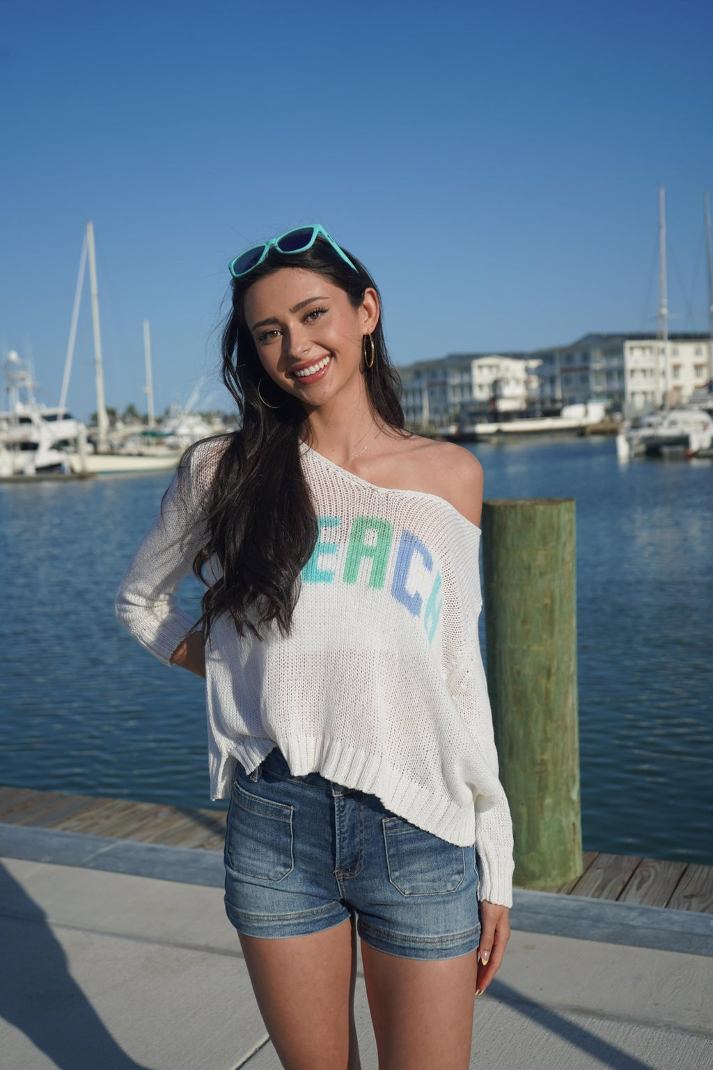 Woman in slouchy 'beach' sweater by marina, showcasing coastal boutique clothing for stylish summer looks. Perfect for Port Aransas!