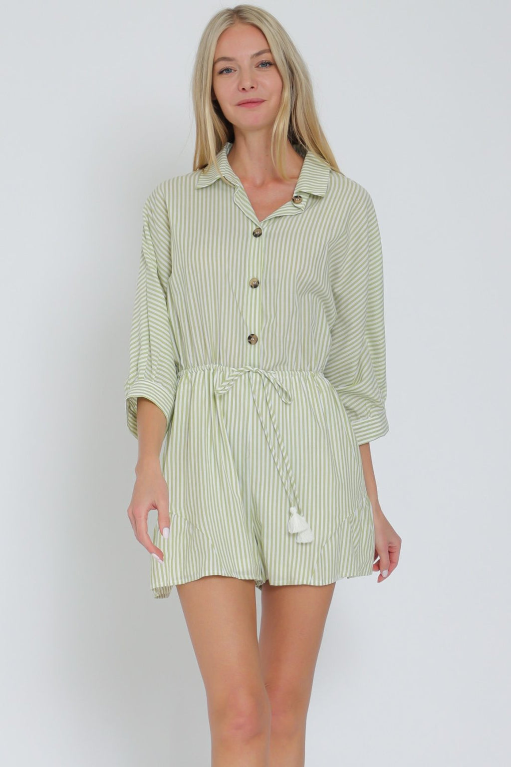 Stylish green striped romper from Port Aransas boutique, perfect for tropical vacations and trendy summer outfits.