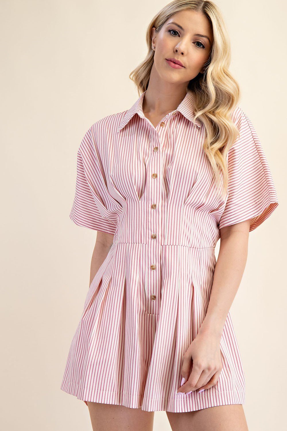 Stylish pink pleated romper with collar neckline, perfect for coastal boutique clothing and tropical vacation dresses.