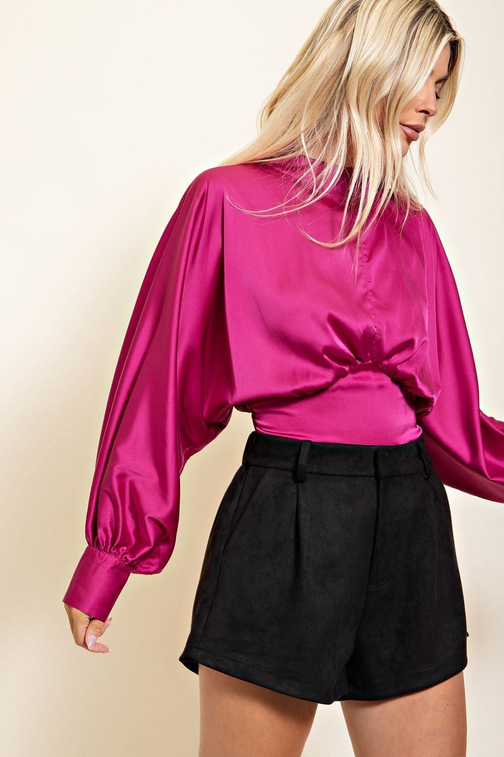 Model wearing BLACK SUEDE SHORTS paired with a vibrant pink blouse from Raggdoll Boutique, perfect for summer outfits.