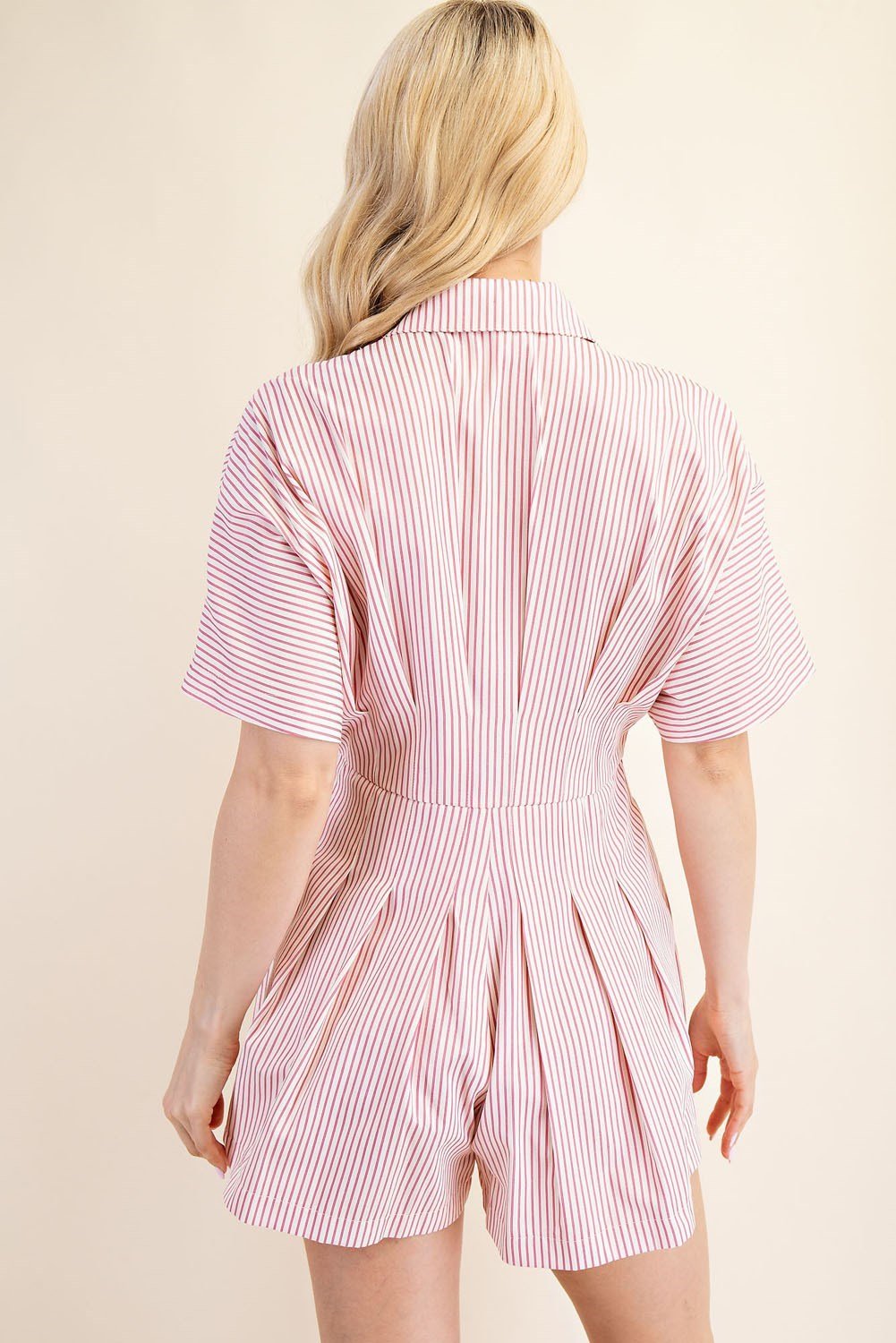 Back view of pink pleated Ember Romper, stylish piece for coastal boutique clothing and curvy plus size fashion.