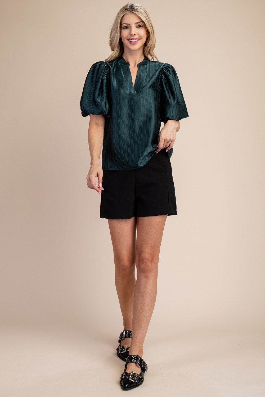 HUNTER GREEN PUFF SLEEVE TOP modeled with black shorts, perfect for trendy coastal style at Raggdoll Boutique.