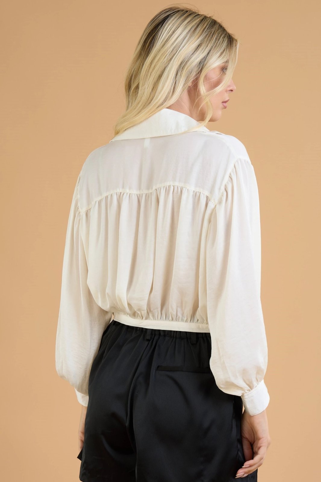 Back view of CREAM TIE-FROMT SATIN TOP from Raggdoll Boutique, showcasing trendy coastal style and summer outfits Texas.