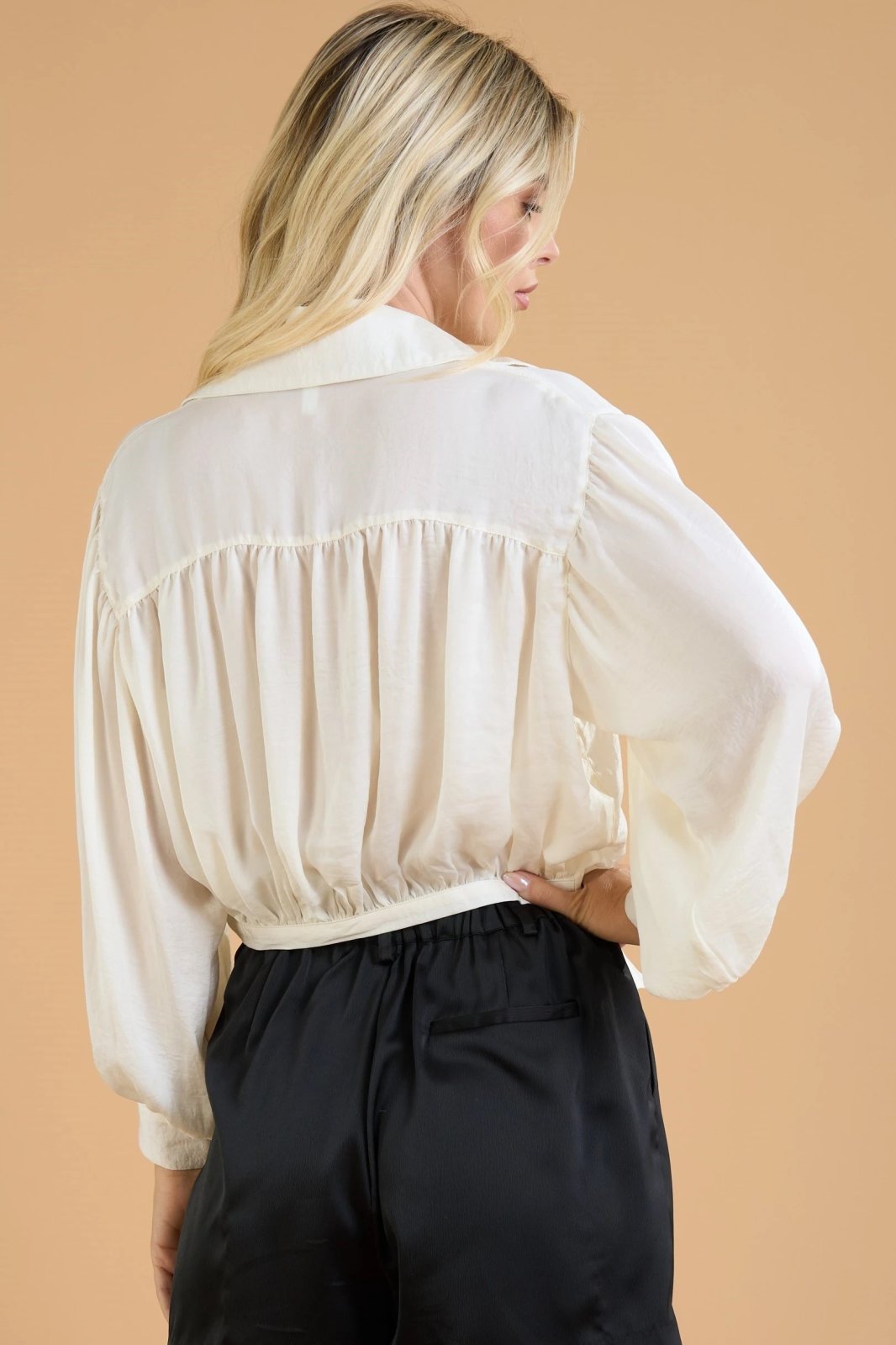 Back view of CREAM FRONT TIE SATIN TOP from Raggdoll Boutique, perfect for trendy coastal style and summer outfits.