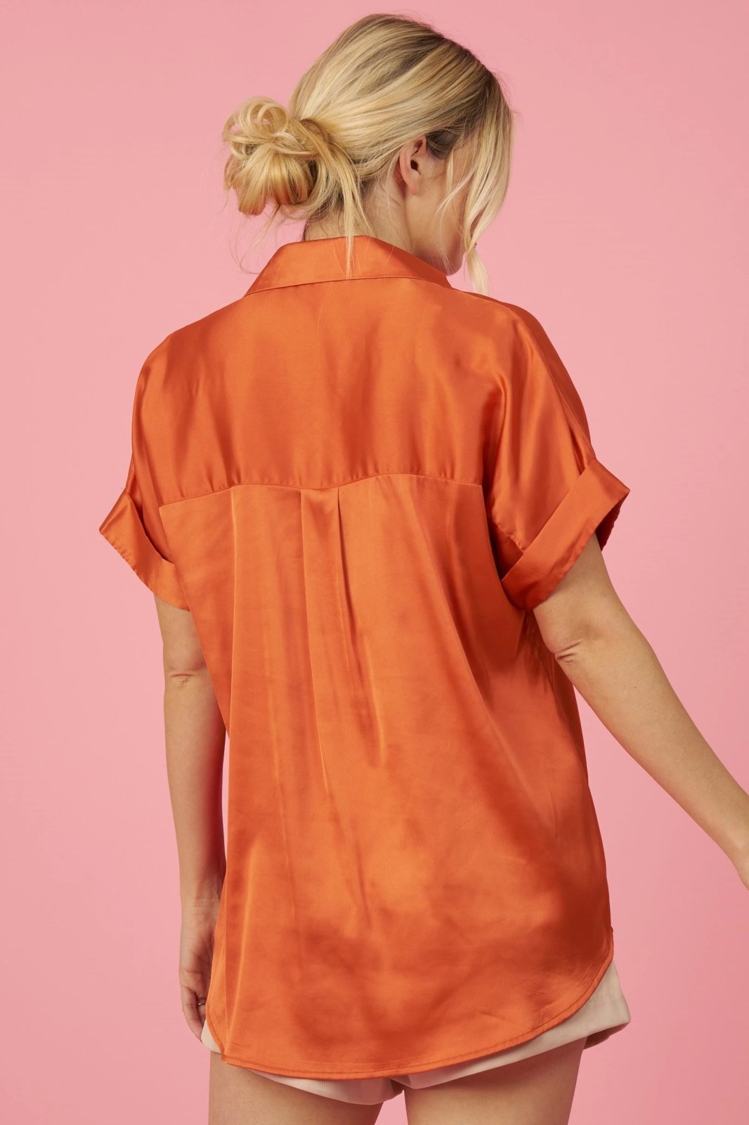 Back view of model wearing an ORANGE COLLARED SATIN TOP from Raggdoll Boutique, showcasing trendy coastal style.