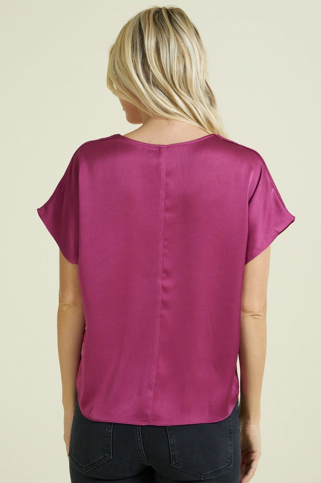 Back view of a woman wearing a MAGENTA TEXTURED SATIN TOP from Raggdoll Boutique, perfect for summer outfits Texas.