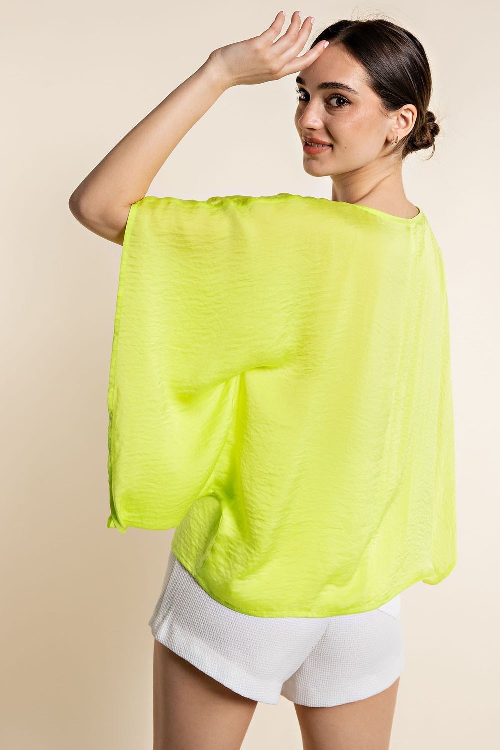 Model wearing a LIME SATIN TOP from Raggdoll Boutique, perfect for a trendy coastal style.