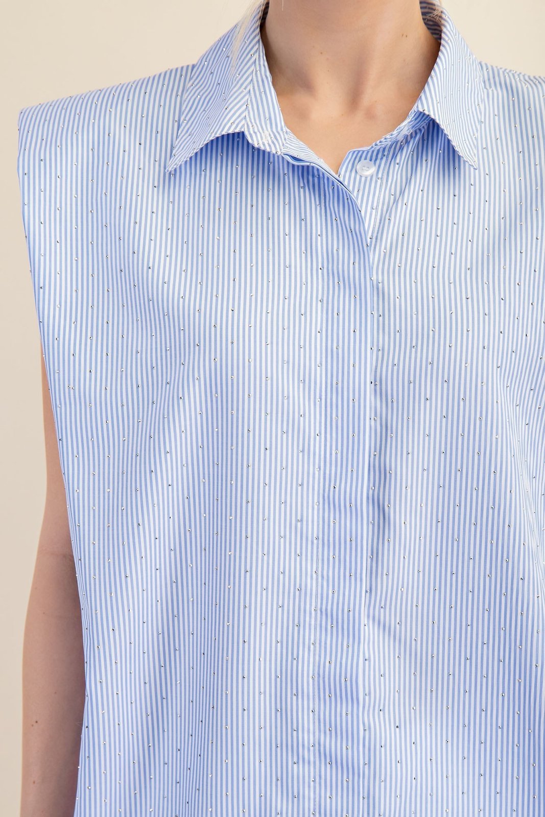 Sky blue shoulder pad shirt with crisp collar and structured design, ideal for coastal boutique clothing and stylish tops for women.