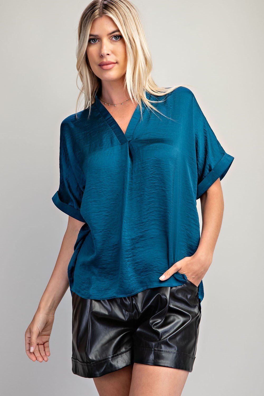 Stylish teal top in a coastal boutique setting, perfect for beach dresses and curvy plus size fashion.