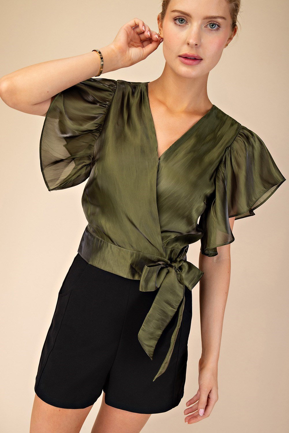 Stylish SHAY Olive Top featuring flutter sleeves and a tie waist, perfect for beach dresses and curvy plus size fashion.