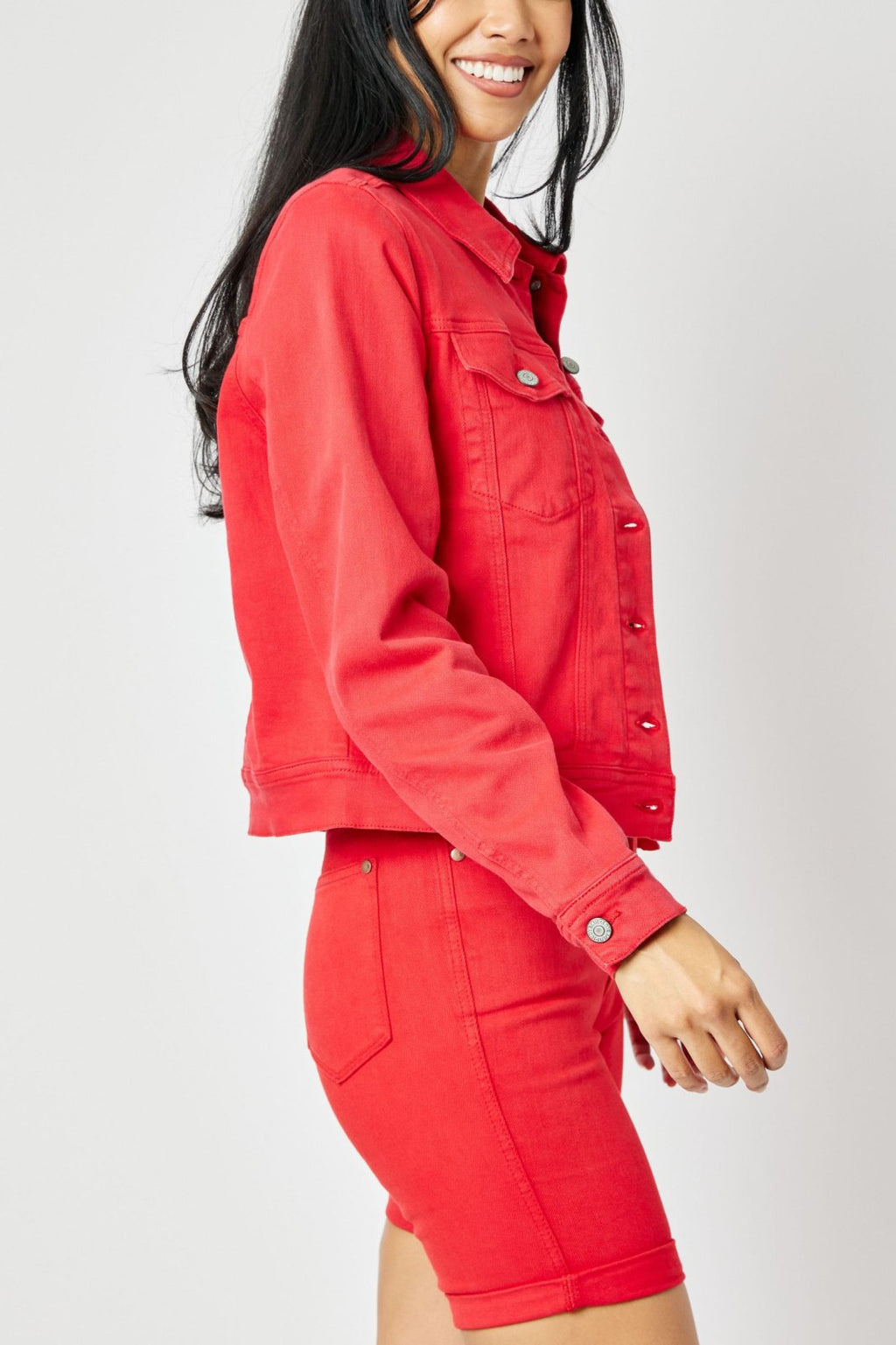 Woman wearing JUDY BLUE PLUS RED DENIM JACKET paired with red denim shorts from Raggdoll Boutique.