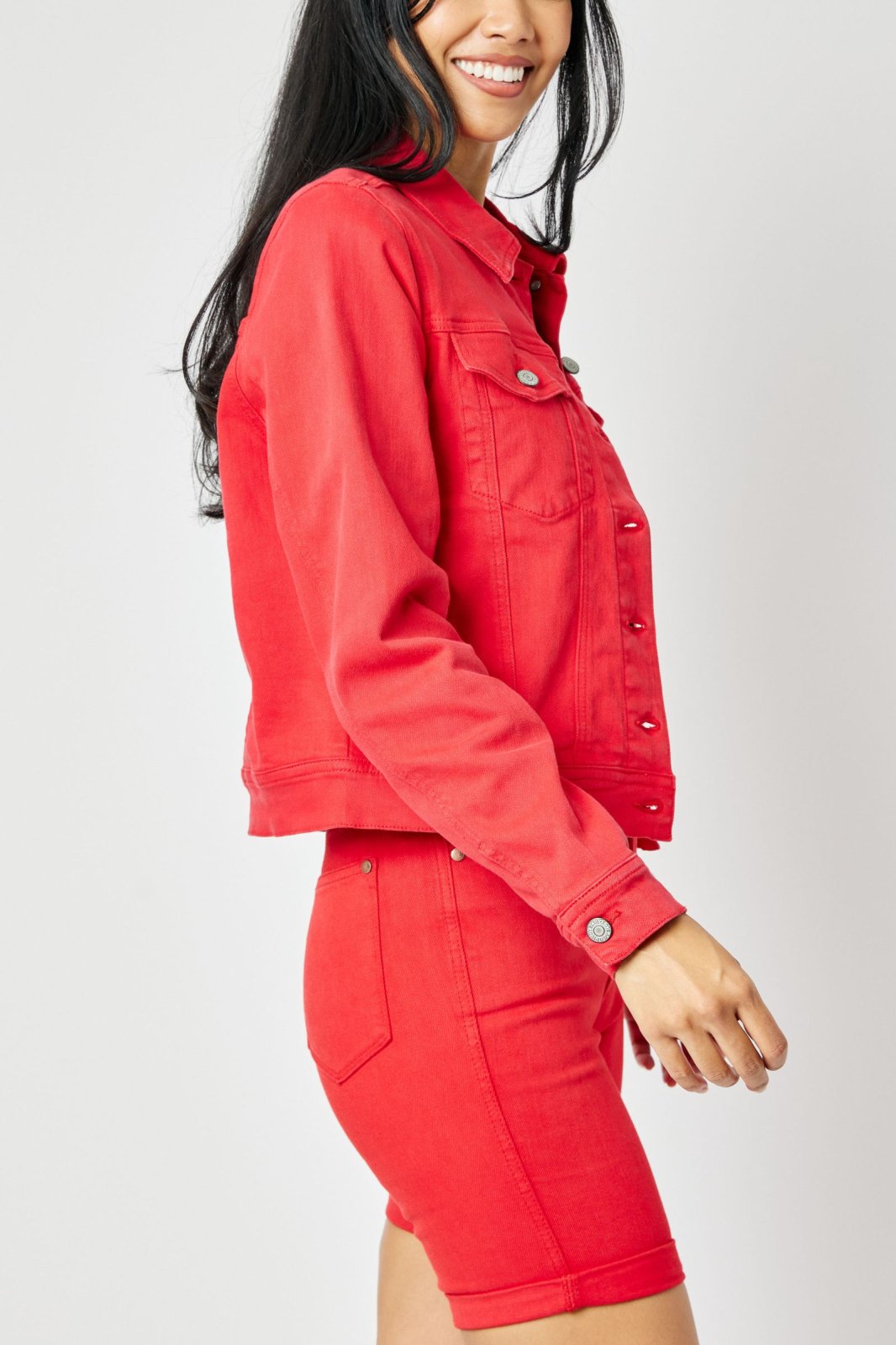 Woman wearing JUDY BLUE PLUS RED DENIM JACKET paired with red denim shorts from Raggdoll Boutique.