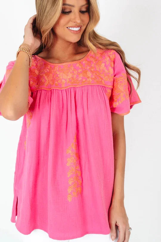 THE COURTNEY TOP in vibrant pink with embroidered details from Raggdoll Boutique, perfect for a trendy coastal style.