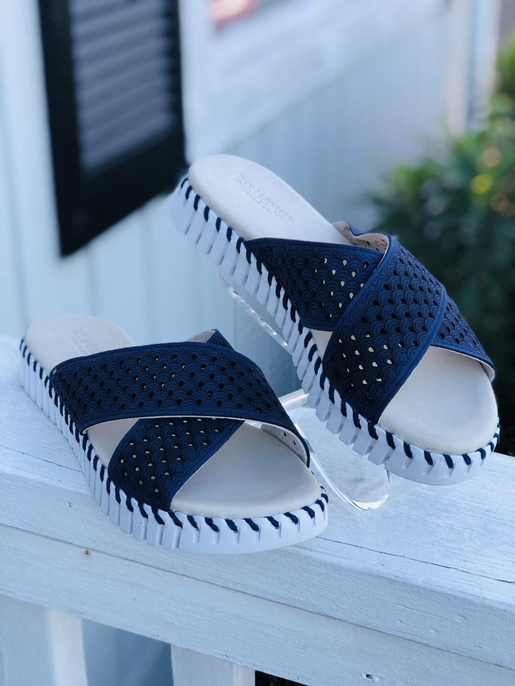 NAVY CROSS BAND SANDALS by ILSE JACOBSEN displayed on a railing, perfect for trendy coastal style and summer outfits Texas.