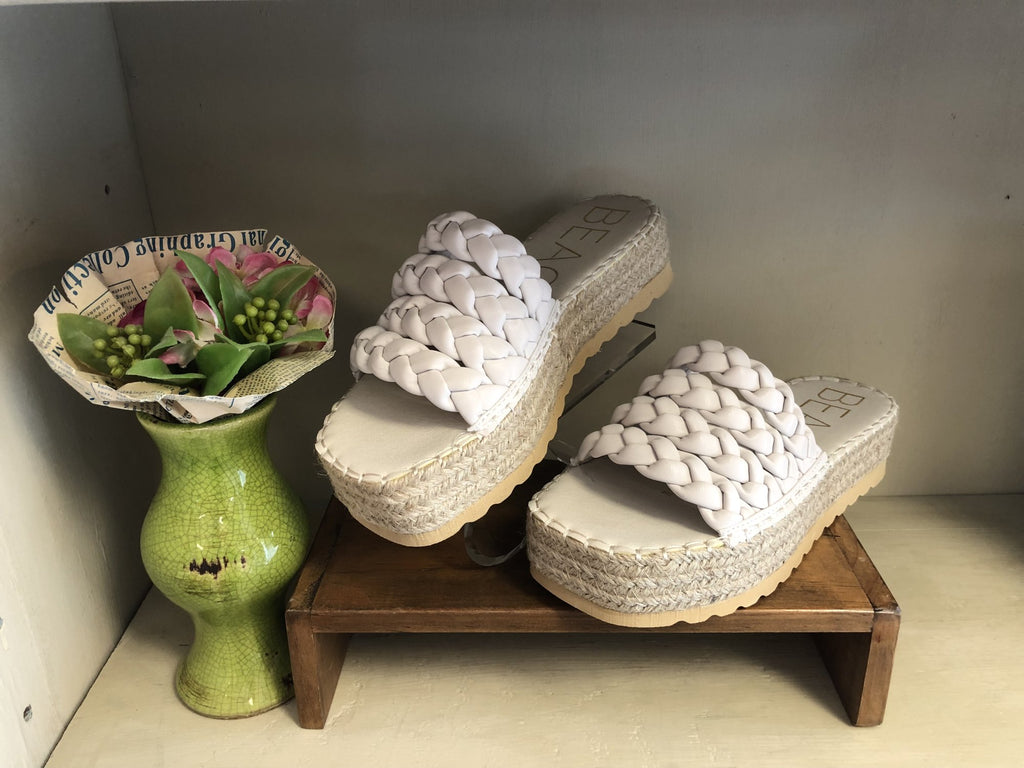 PACIFIC SANDAL displayed on a wooden stand with a decorative vase at Raggdoll Boutique, a coastal fashion boutique.