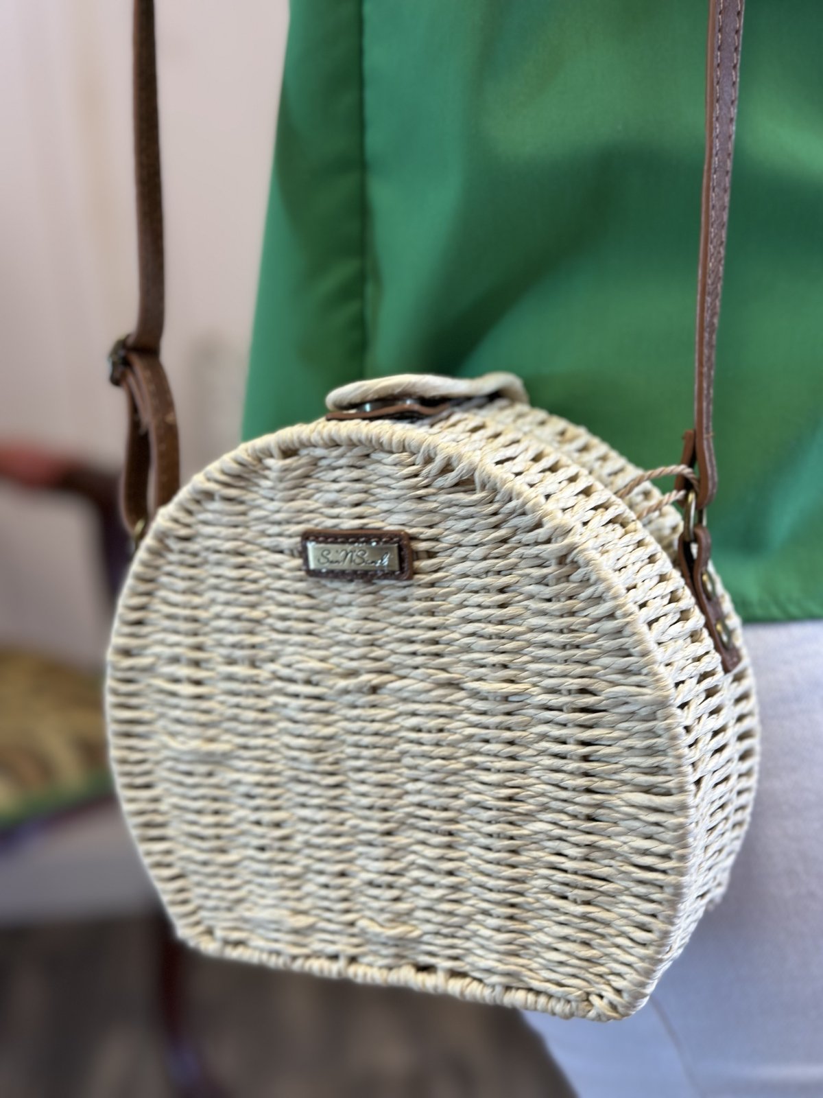 Natural straw crossbody bag, perfect for coastal boutique clothing and tropical vacation dresses.