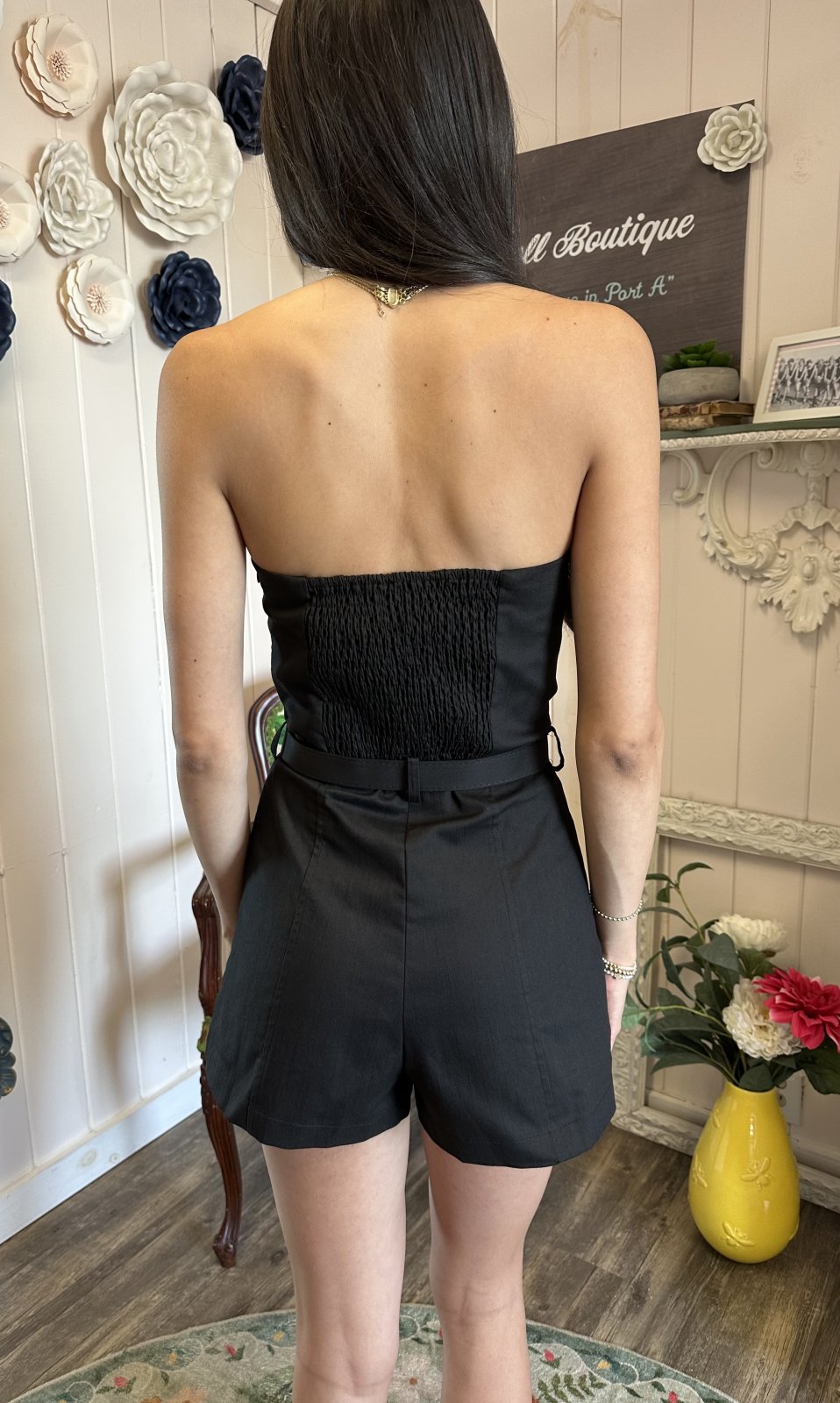 Back view of a black strapless bustier romper, perfect for coastal boutique clothing and curvy plus size fashion.