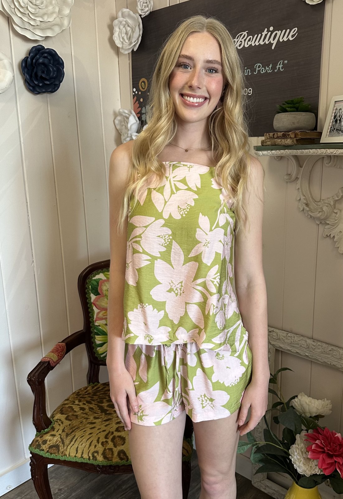 Green floral short set with pink flowers, perfect for summer. Ideal for coastal boutique clothing and tropical vacation vibes.