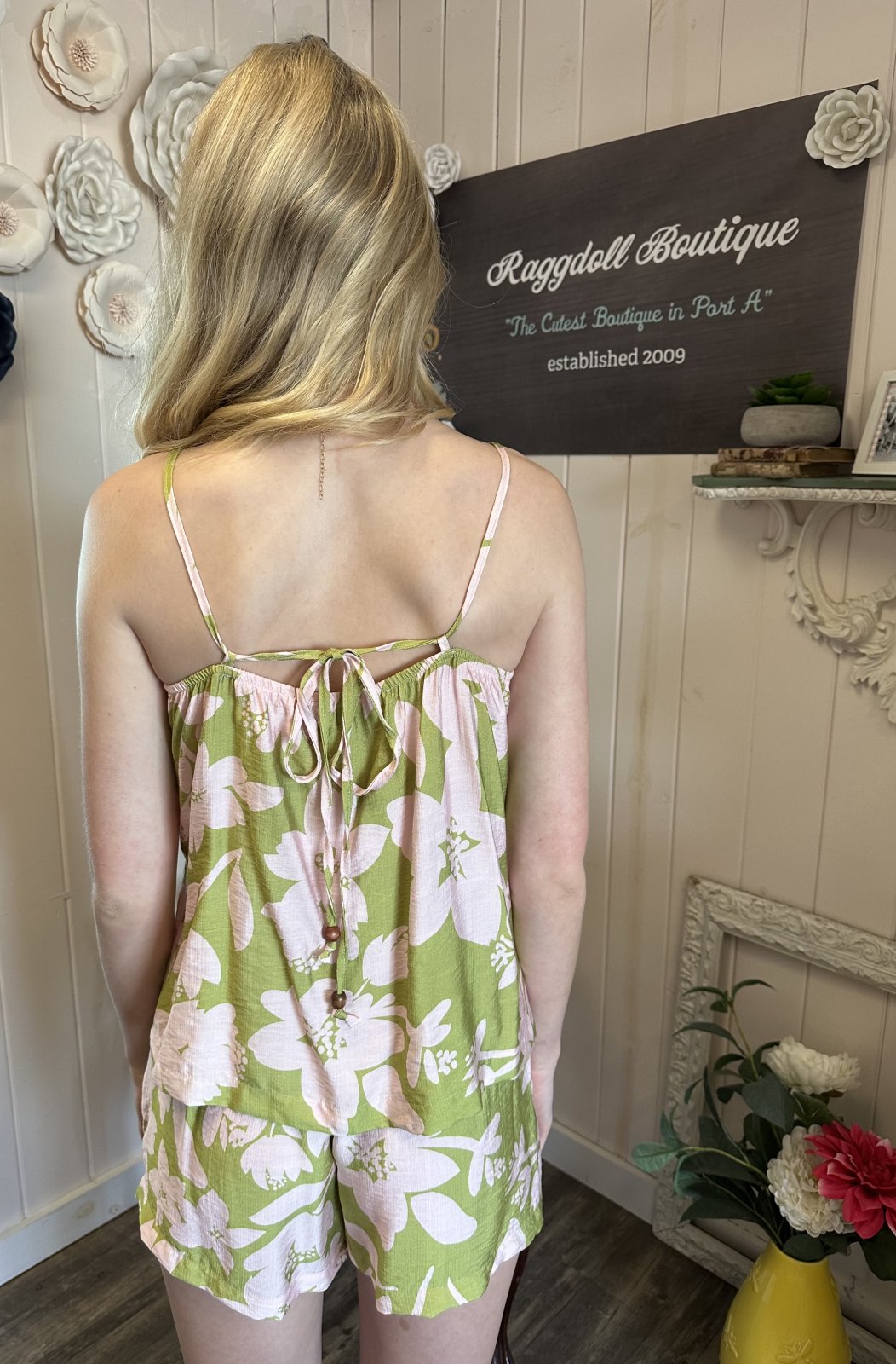 Green floral short set with pink flowers, perfect for beach outings, featured at Raggdoll Boutique, coastal women's fashion.