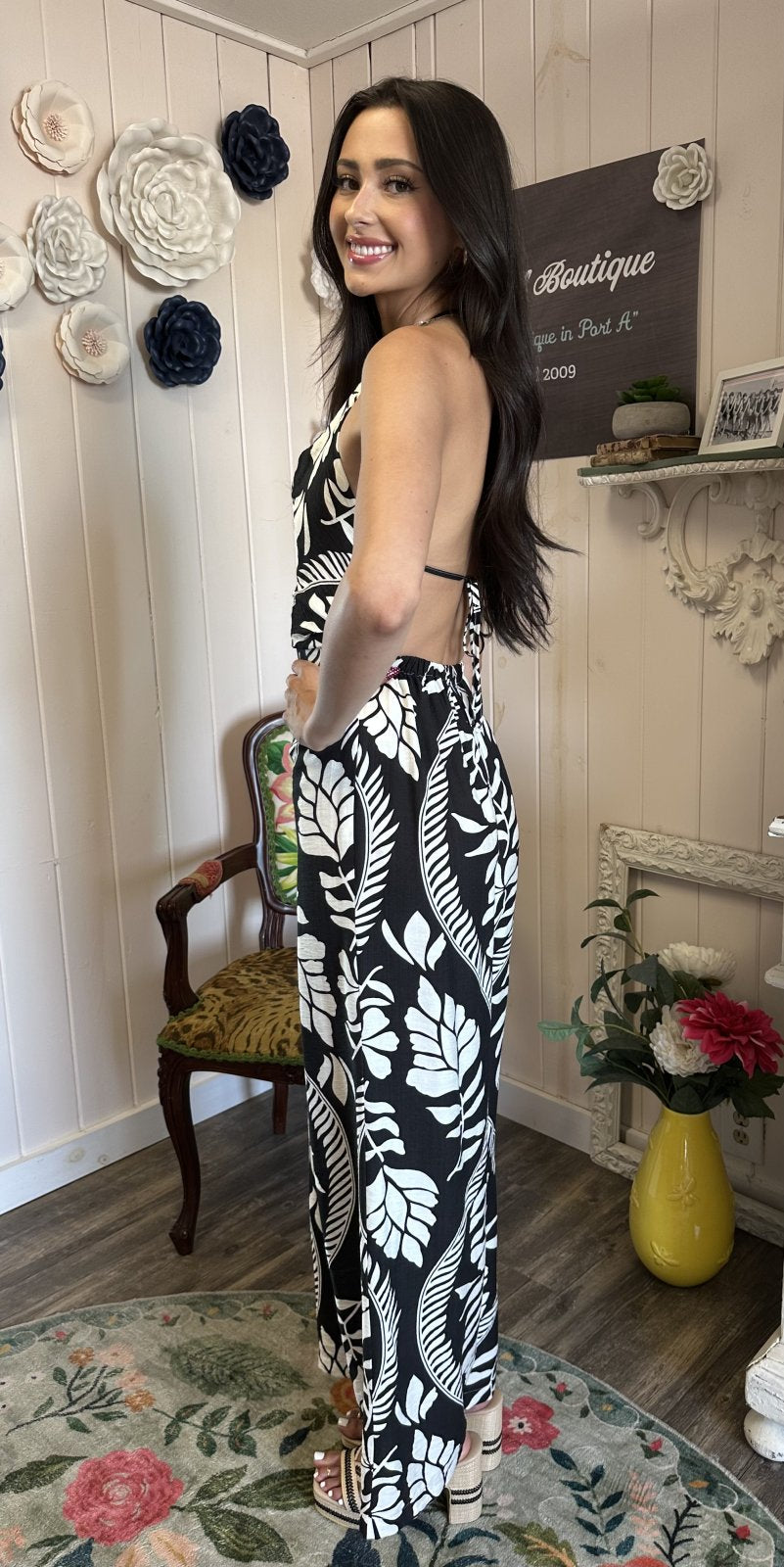 Elegant black and white floral jumpsuit from coastal boutique clothing, perfect for tropical vacations and special occasions.