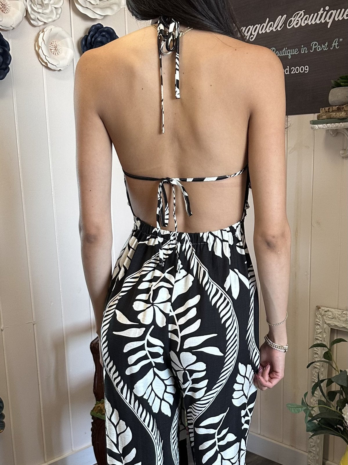Back view of Malia Jumpsuit featuring tie detail, perfect for coastal boutique clothing and tropical vacation dresses.