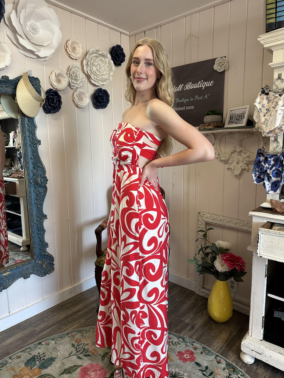 Stylish model in red and ivory halter jumpsuit from coastal boutique clothing, perfect for summer parties and vacations.