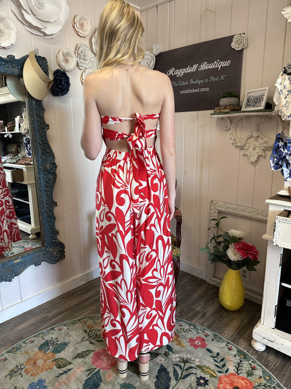 Back view of Lena Jumpsuit in red and ivory, perfect for summer parties, featuring halter ties and a curvy fit.
