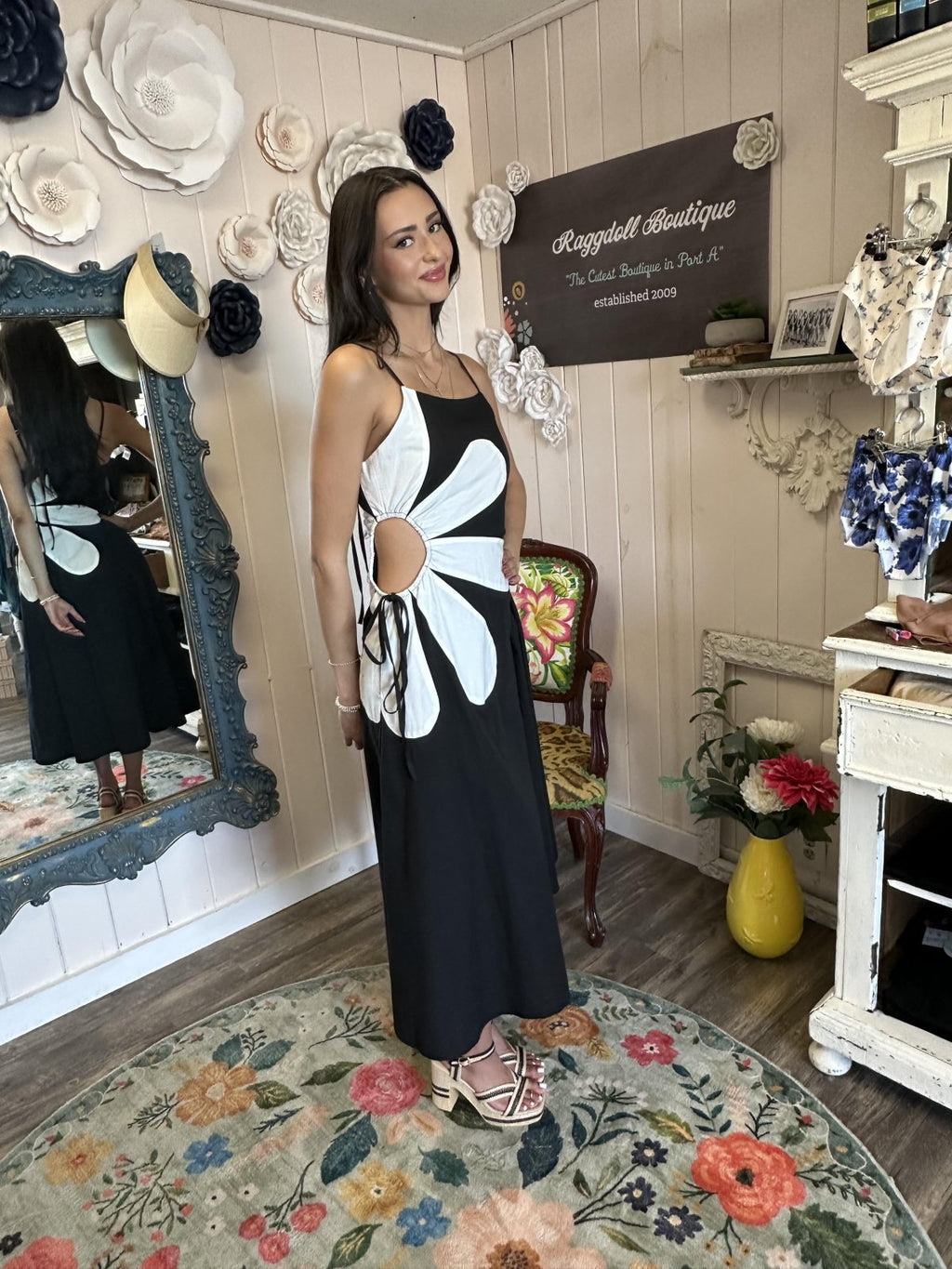 Stylish black and off-white sleeveless Abigail Dress with floral detail, ideal for coastal boutique clothing and tropical vacations.