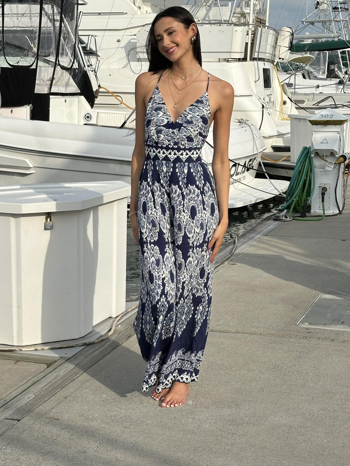 Navy and white sleeveless jumpsuit from coastal boutique clothing, ideal for tropical vacations and stylish outings.