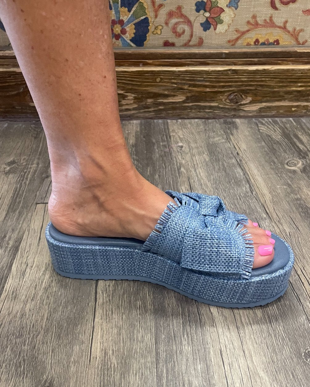 Marina Blue sandals on a woman's foot, perfect for beach dresses and coastal boutique style. Ideal for tropical vacations.