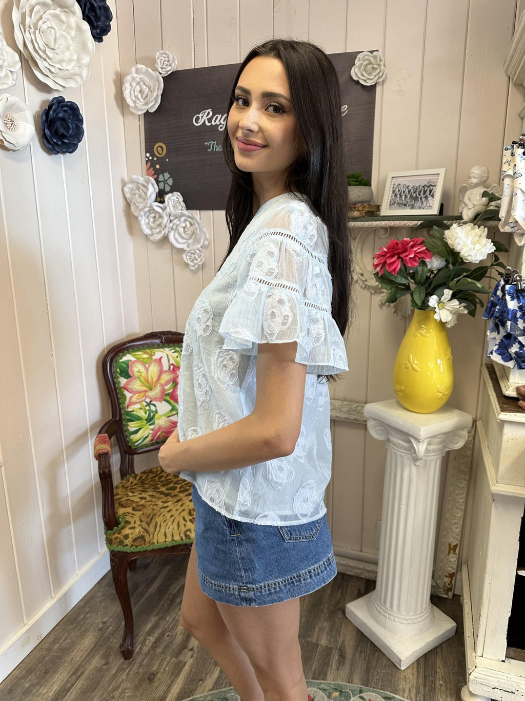 Light blue flowy top with embroidered flowers, perfect for coastal boutique clothing and beach outings. Stylish women's fashion.