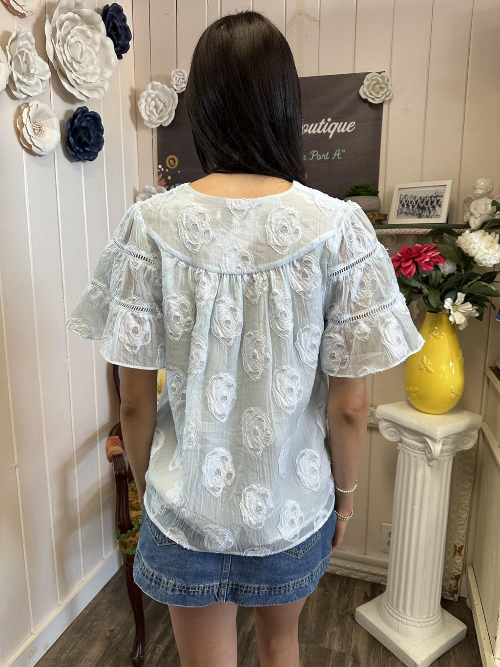 Light blue flowy top with floral embroidery, perfect for coastal boutique clothing and summer outings.
