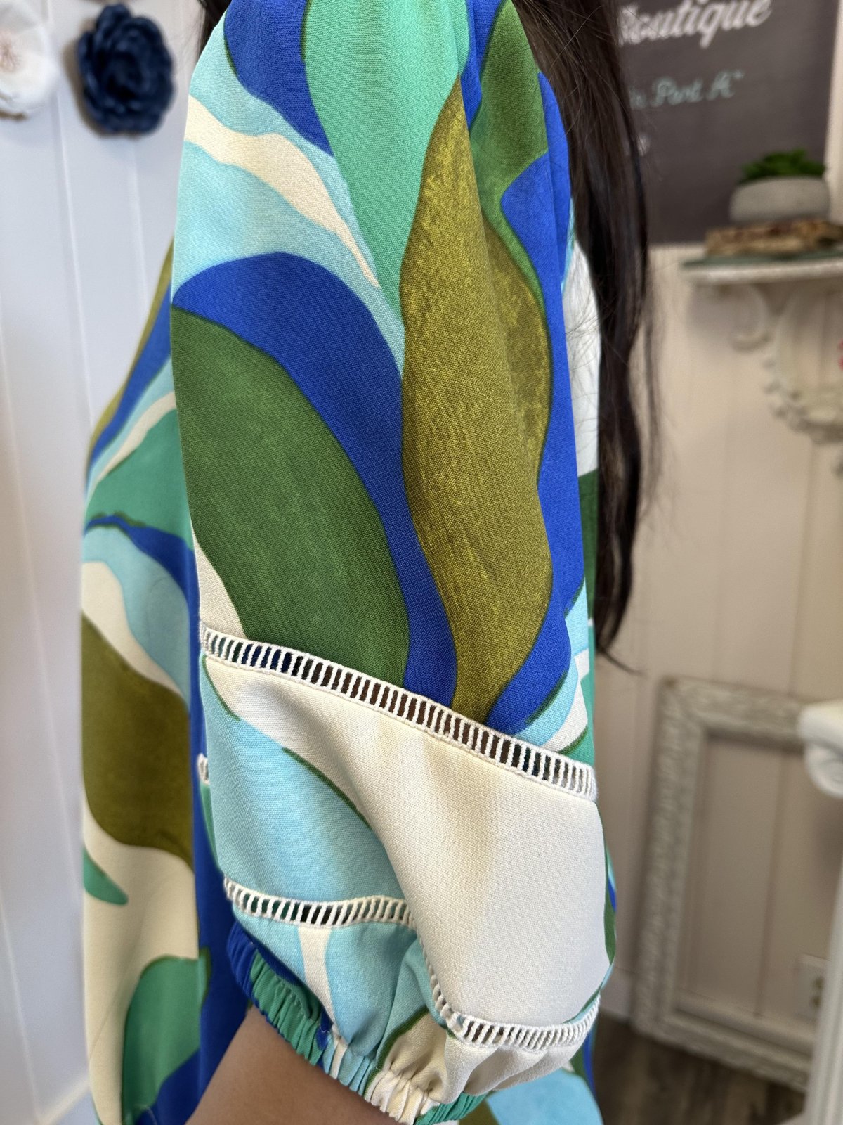 Vibrant tropical leaves print Esme Top with detailed sleeves; perfect for coastal boutique clothing and summer outings.