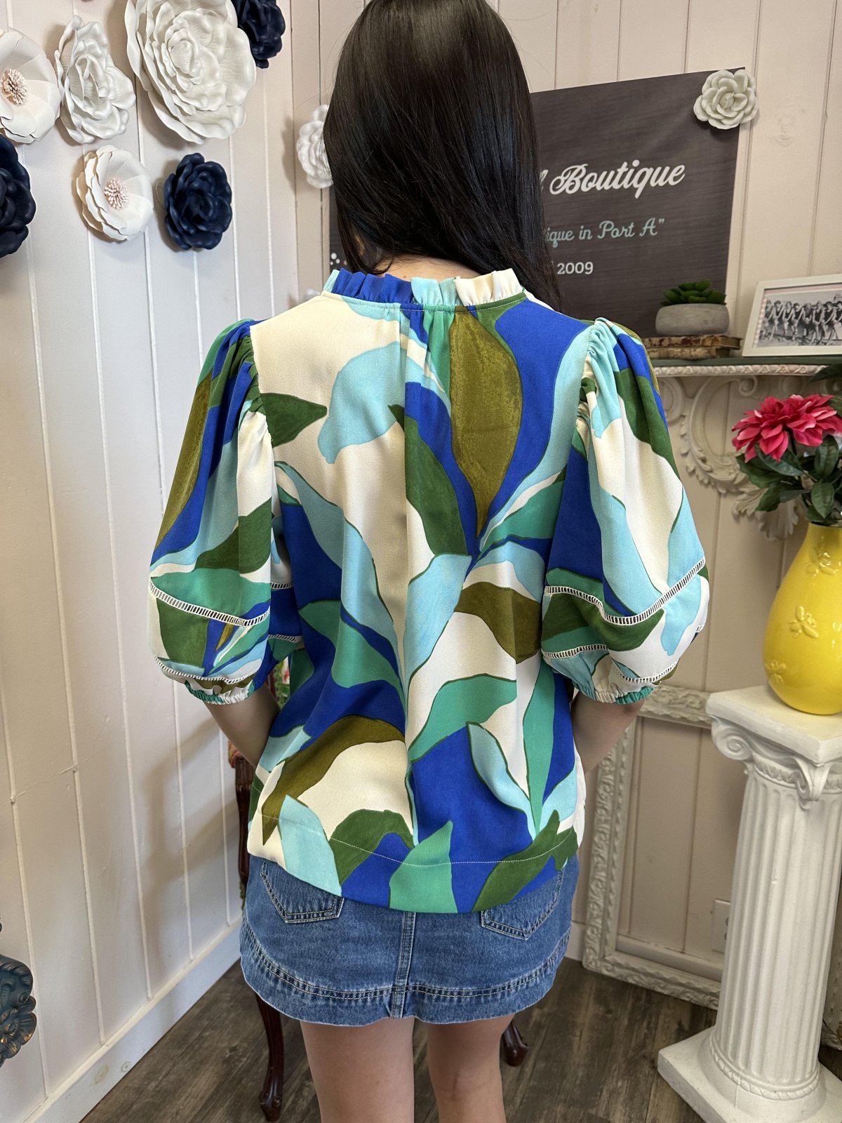 Back view of Esme Top featuring vibrant tropical leaves print, perfect for summer outings and beach days in stylish coastal boutique clothing.